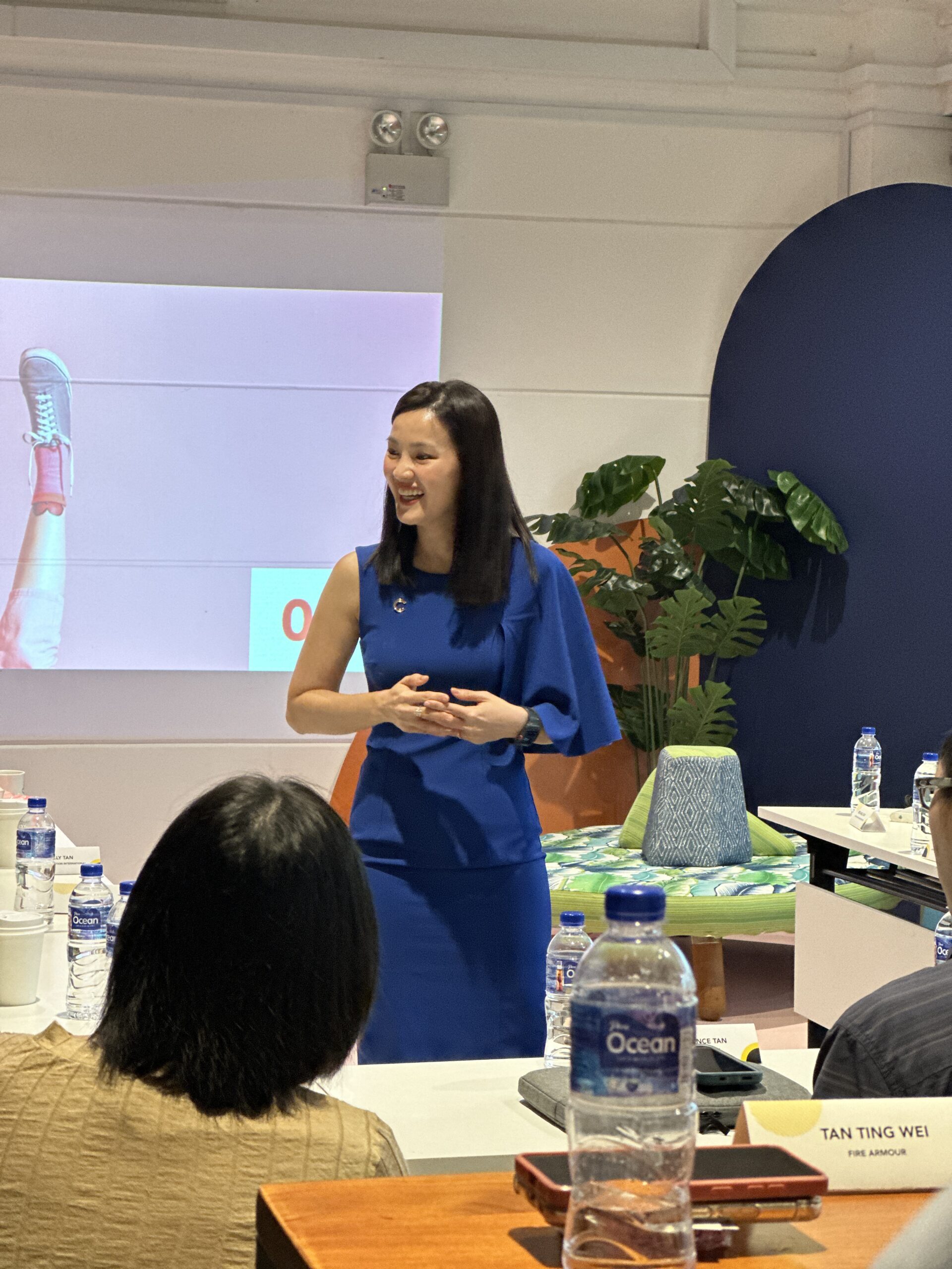 Master trainer facilitating learning during a design thinking workshop